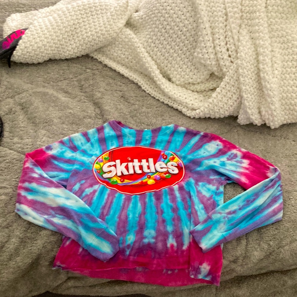 The size is an XS and the color of it is a mixture of pink,purple,and blue.